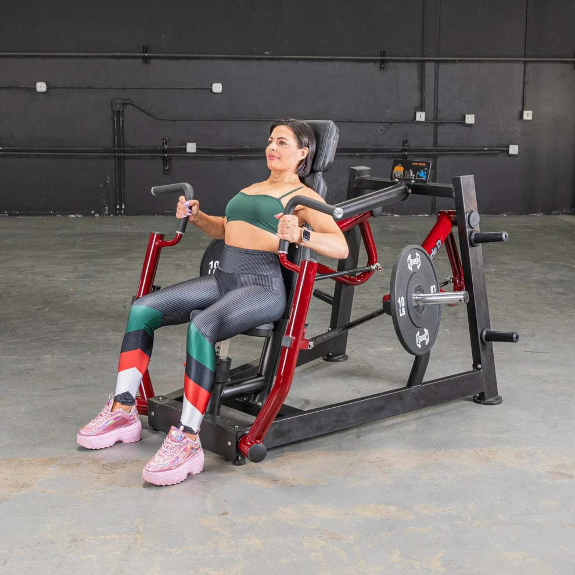 Female completing chest press on Muscle D Power Leverage V2 machine.