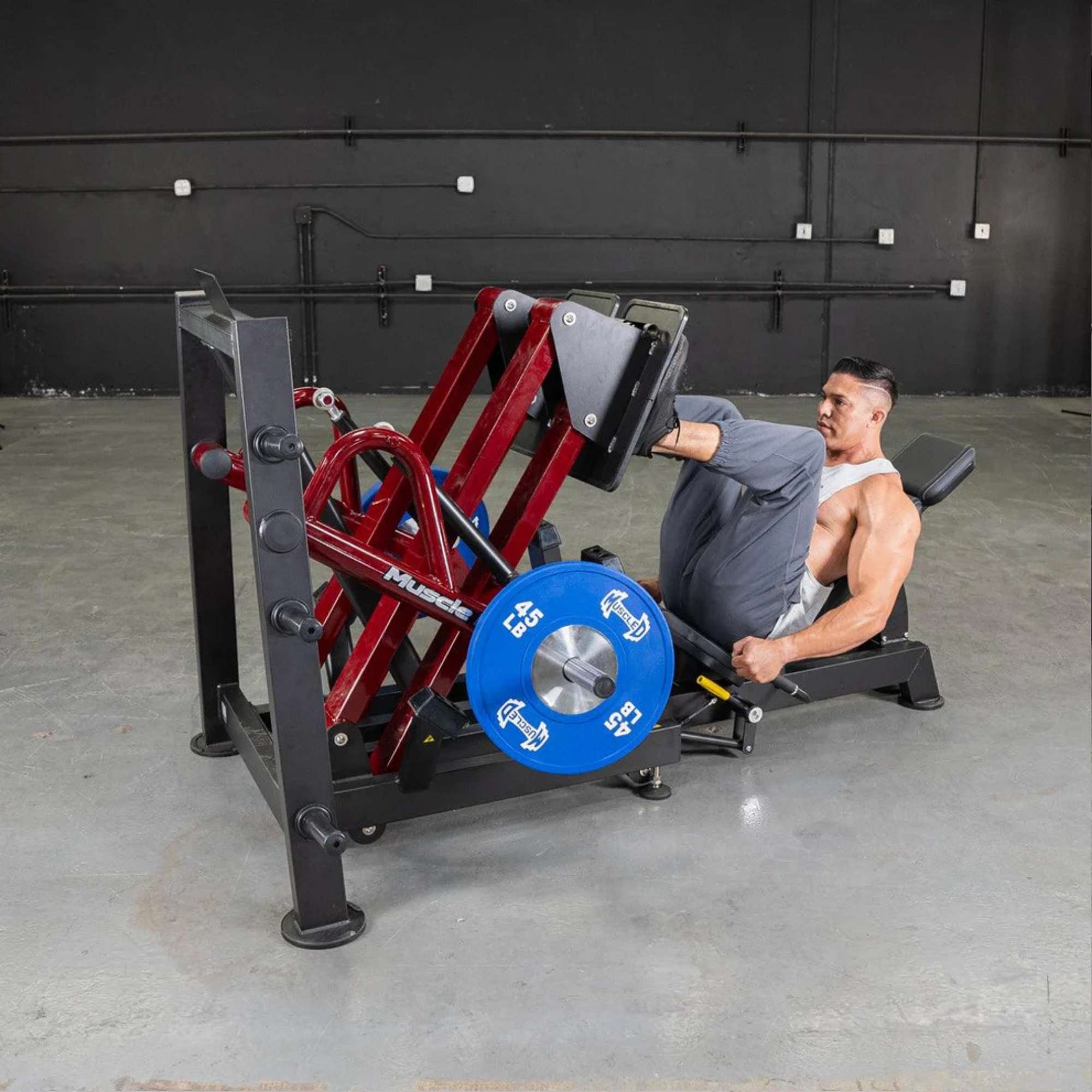 Male athlete executing a leg press on the Muscle D Power Leverage V2 for focused leg muscle isolation and balance training.