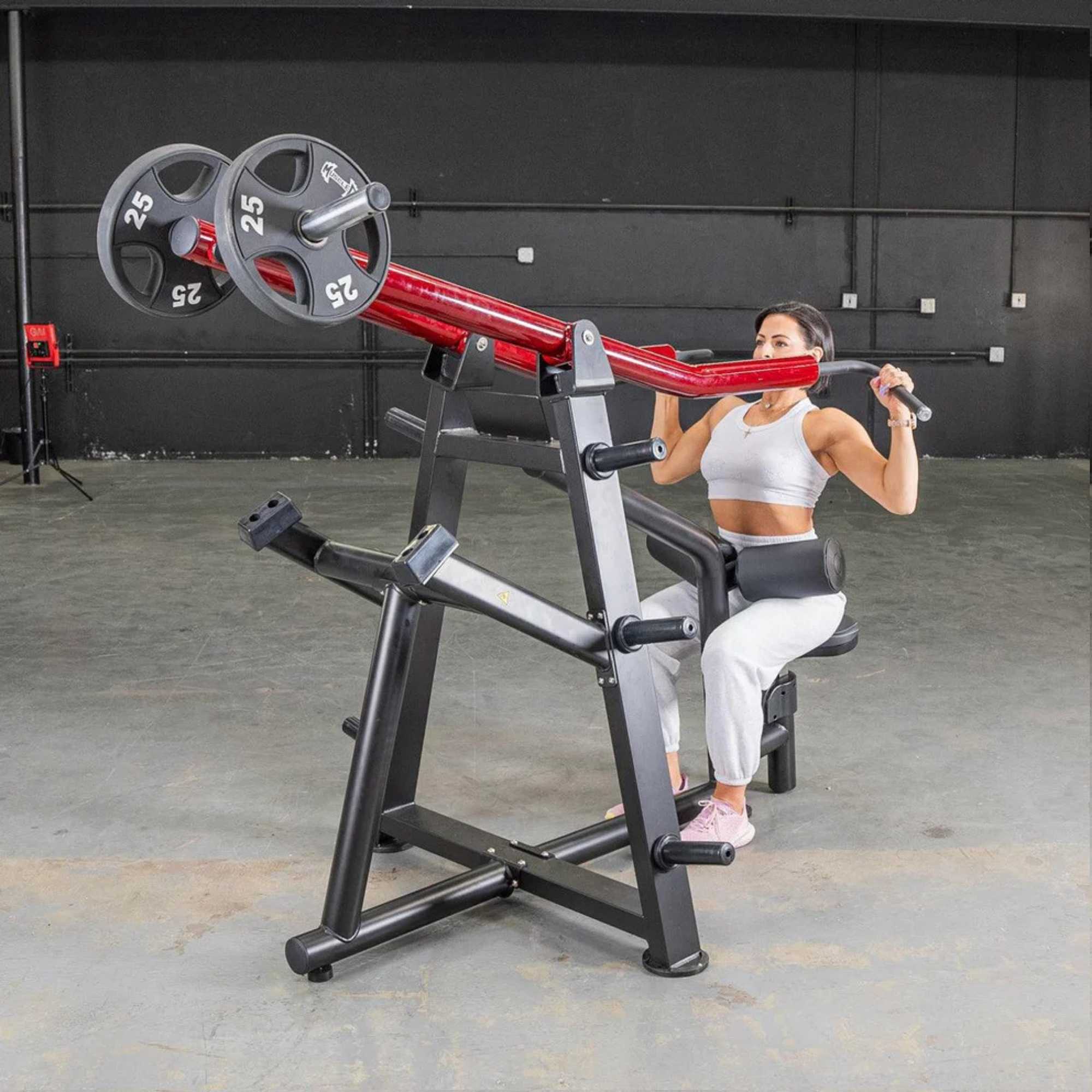 Muscle D Power Leverage V2 Iso-Lateral Lat Pulldown with 25-lb Olympic plates, demonstrating a seated pulldown motion.