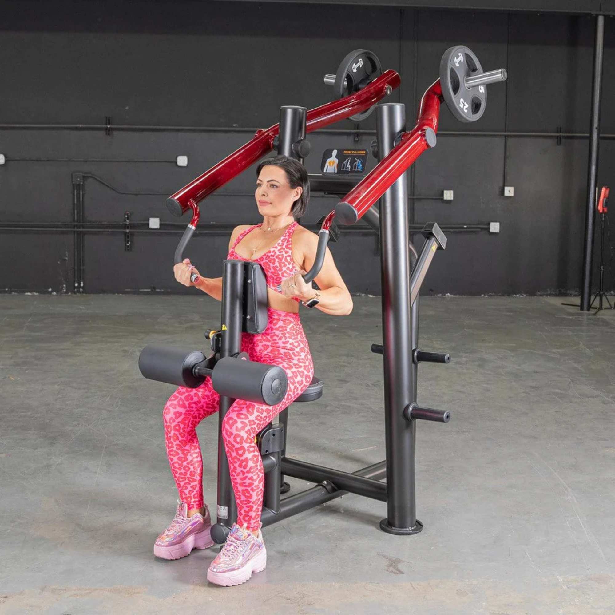 Angle of a person using the Muscle D Power Leverage V2 Reverse Grip Lat Pulldown, focusing on the arm movement and 25 lb plates