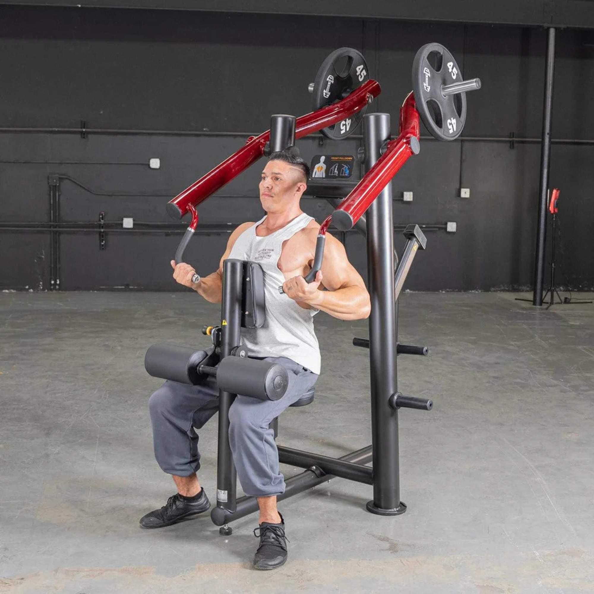 Person using the Muscle D Power Leverage V2 Reverse Grip Lat Pulldown with 45 lb urethane-coated Olympic plates, showing the chest press in action.