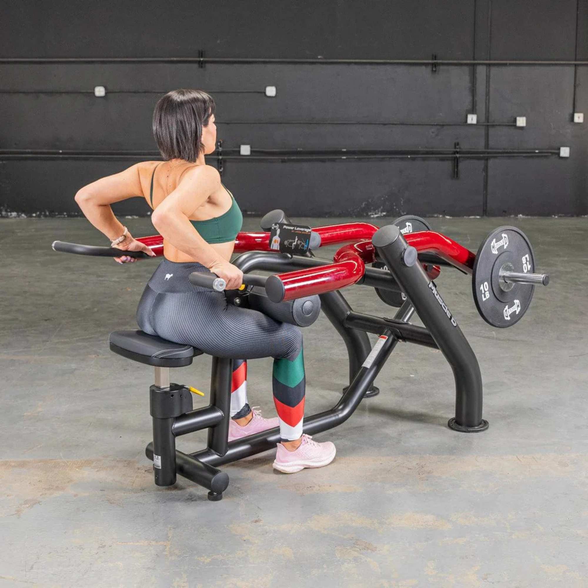 Muscle D Power Leverage V2 Seated Dip Triceps Press Machine PL-PV2-DP - Male performing triceps press with Olympic plates for strength training.