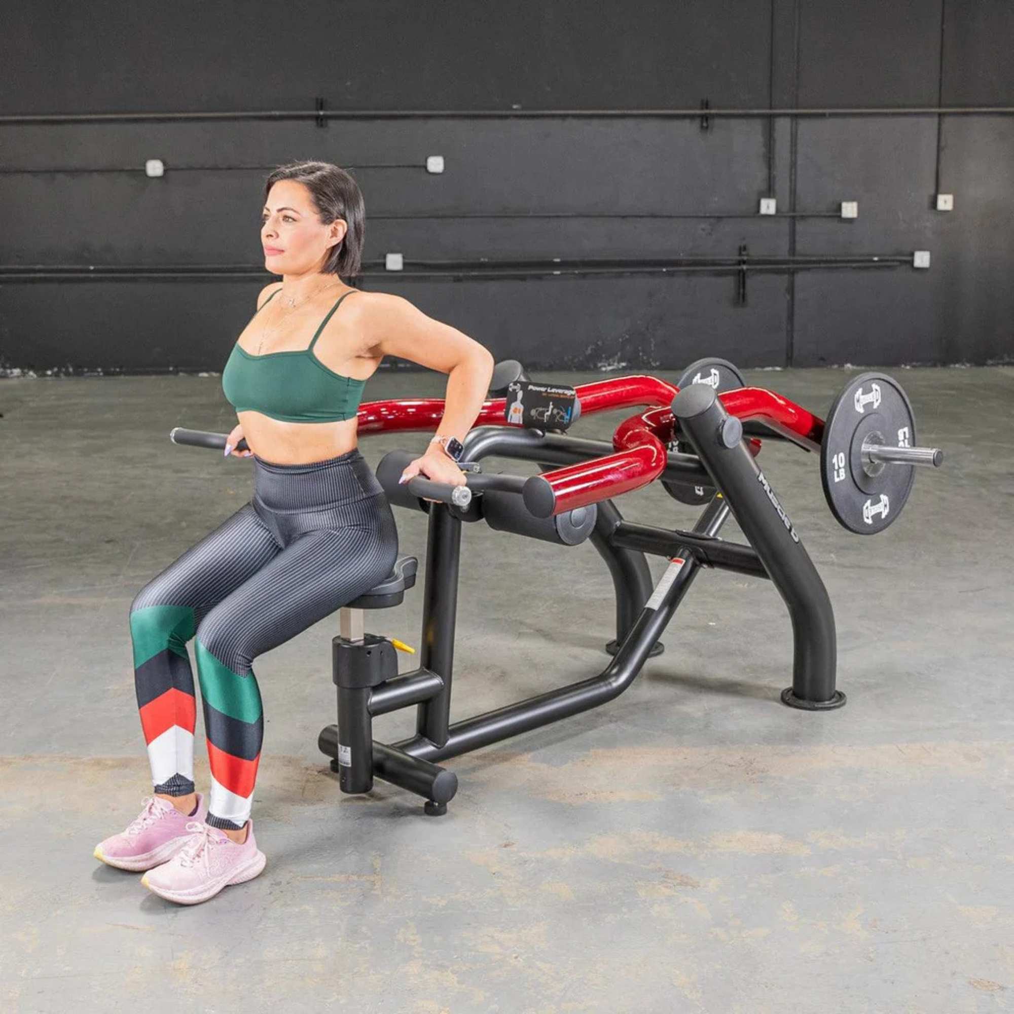 Muscle D Power Leverage V2 Seated Dip Triceps Press PL-PV2-DP with Urethane Coated Olympic Plates - Female performing tricep dip exercise.