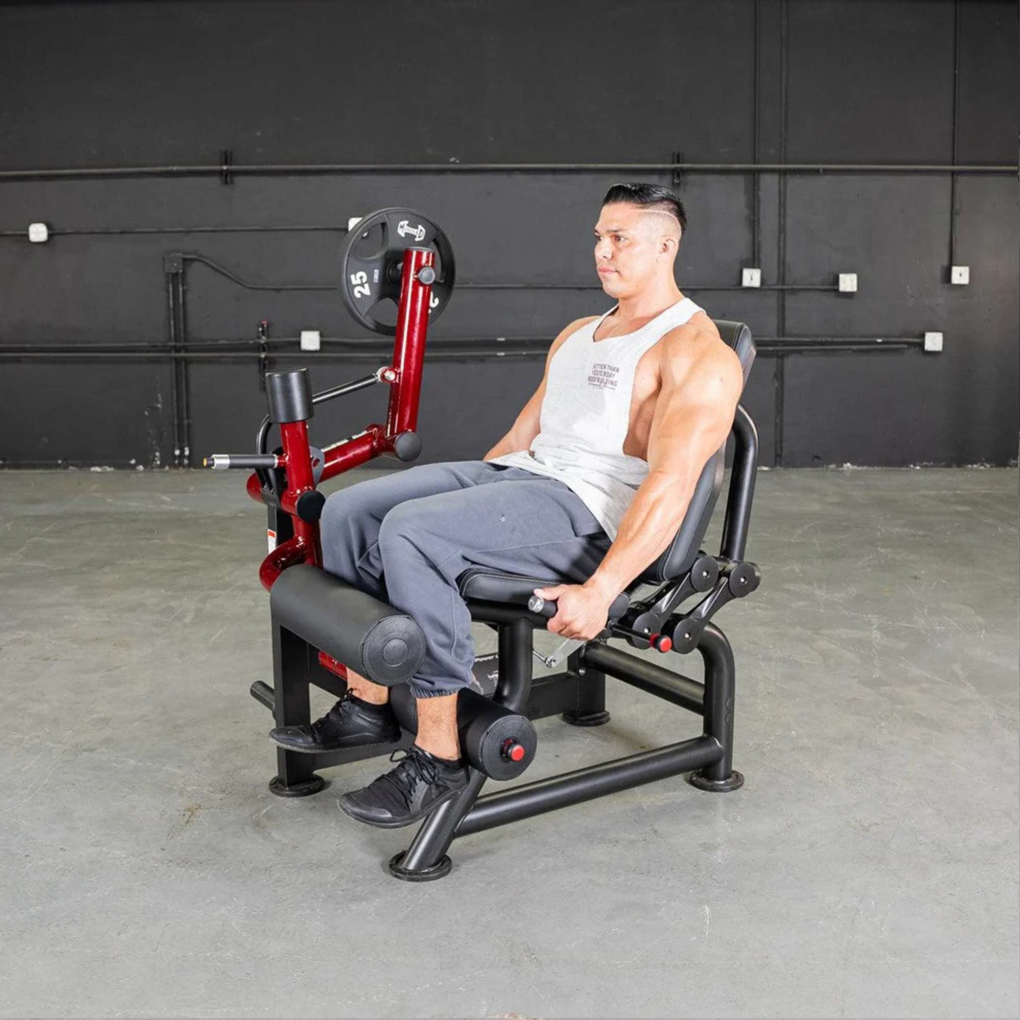 Muscle D Power Leverage V2 Seated Leg Curl with 25-lb Olympic plates, showcasing strength-training capability.