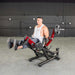 Person using the Muscle D Power Leverage V2 Seated Leg Extension / Prone Leg Curl Combo PL-PV2-LELC with 25 lb Olympic plates, showing the Leg raise in action shot.