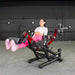 Person using the Muscle D  Power Leverage V2 Seated Leg Extension / Prone Leg Curl Combo PL-PV2-LELC with 25 lb Olympic plates, showing female Leg in action shot.