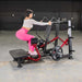 Muscle D Power Leverage V2 Standing Abductor PL-PV2-SA showcasing effective glute and leg workout with user.