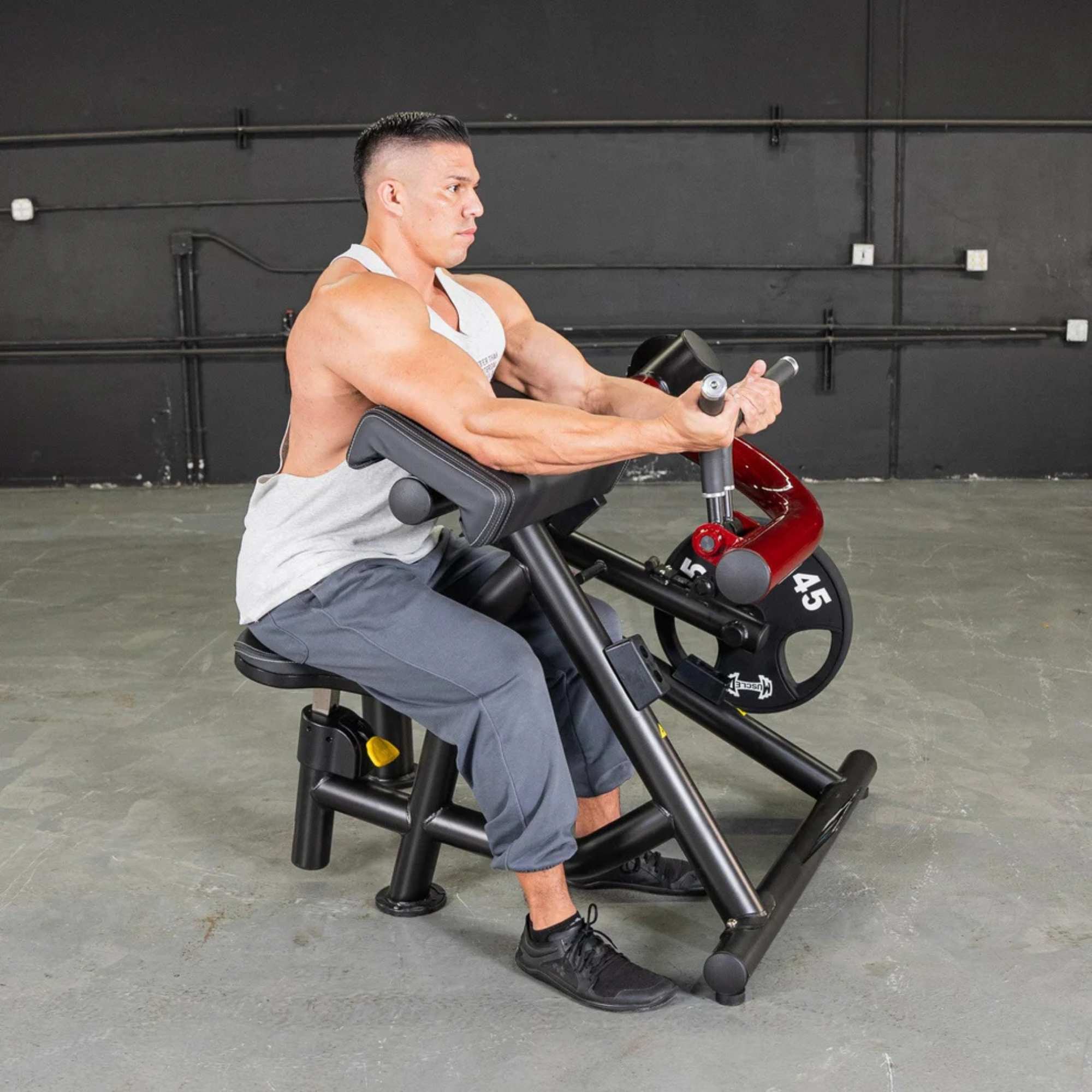 Muscle D Power Leverage V2 Biceps Curl Preacher Curl Machine PL-PV2-BC - Male demonstrating bicep curl workout with Olympic weight plates.