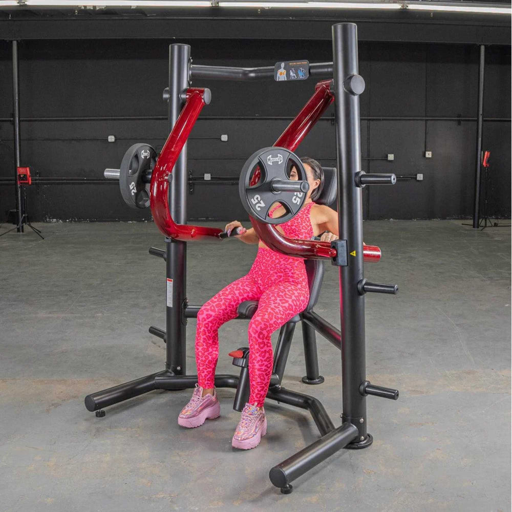 Person performing the exercise on the Power Leverage V2 Decline Chest Press with 25 lb urethane-coated Olympic plates on both sides.