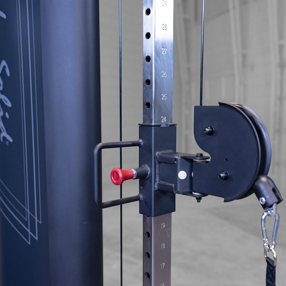 Close-up of a weightlifting machine with pulley system and red safety handle on a Body-Solid Pro ClubLine S2CCX Series II Cable Column in black