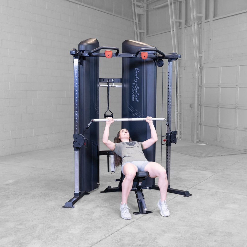Woman doing chest press with a cable pulley bar on a Body-Solid Pro ClubLine S2CCX Series II Cable Column in black