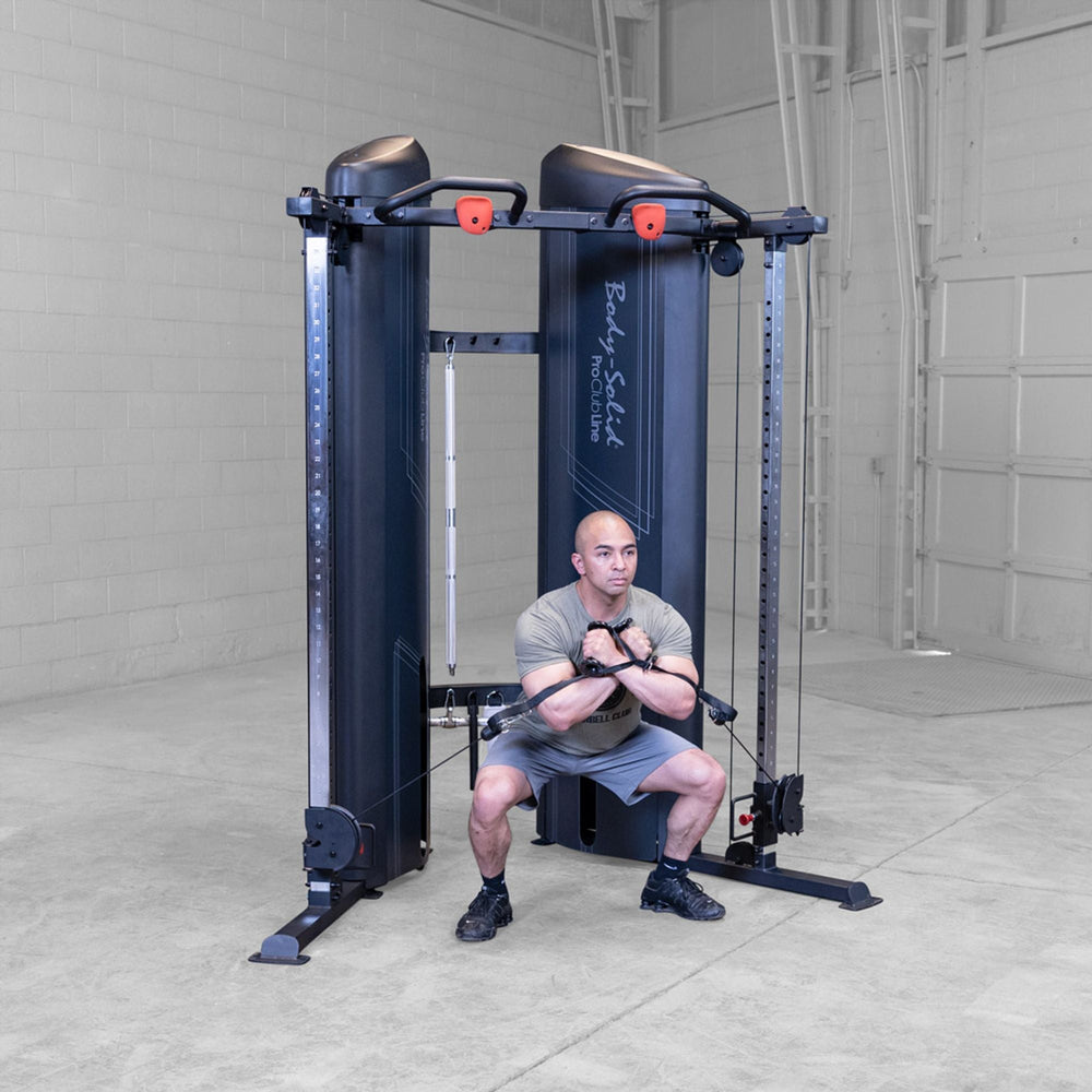 Man performign squat with a Body-Solid Pro ClubLine S2CCX Series II Cable Column in black