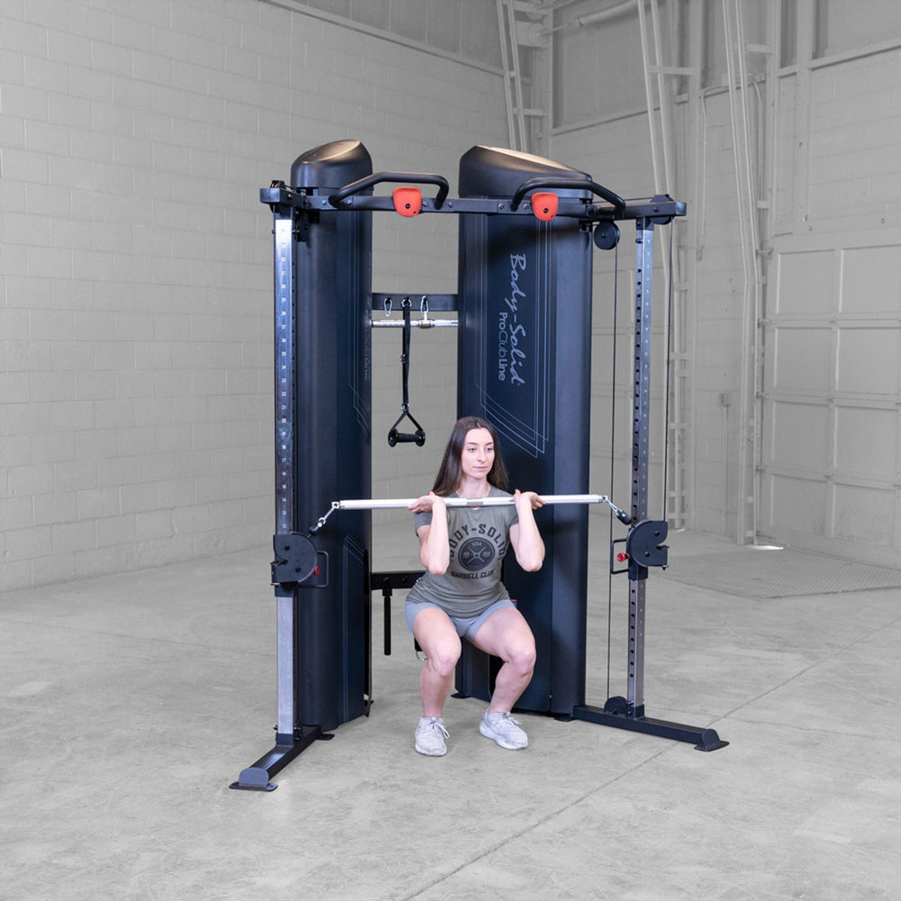 Woman doing squats on a Body-Solid Pro ClubLine S2CCX Series II Cable Column in black
