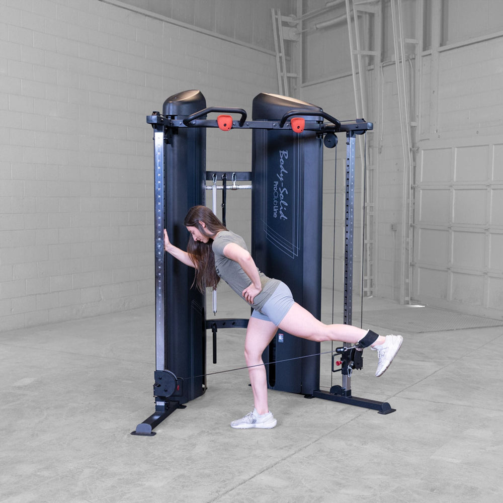 Woman doing rear leg glute kickbacks on a Body-Solid Pro ClubLine S2CCX Series II Cable Column in black