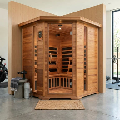 SunRay Bristol Bay 4-Person Corner Infrared Sauna HL400KC with Carbon Nano Heaters in a modern indoor setting with exercise equipment.