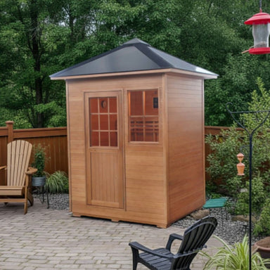 SunRay 3 Person Outdoor Tradtional Sauna with a black roof on a patio surrounded by greenery