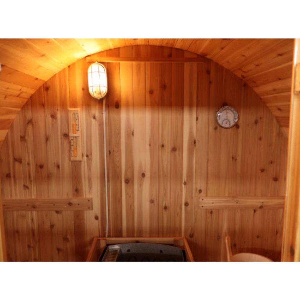SunRay-Aurora 2-4 person Barrel Sauna interior of a sauna with a clock and light fixture.