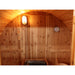 SunRay-Aurora 2-4 person Barrel Sauna interior of a sauna with a clock and light fixture.