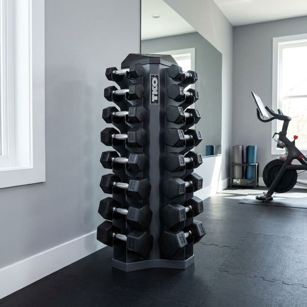 Stack of TKO dumbbells on a rack in a home gym setting