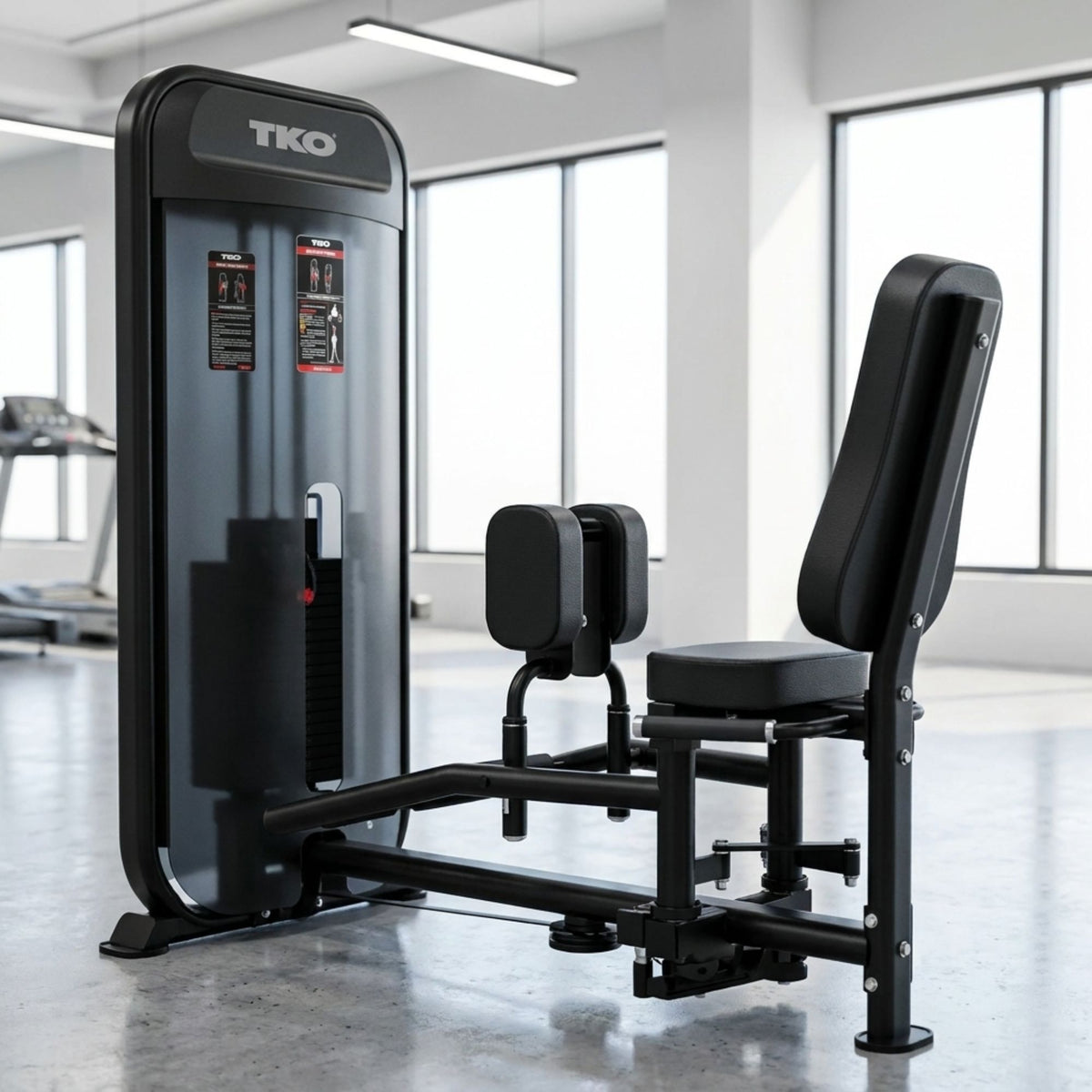 Black TKO TKO Achieve Dual Inner / Outer Thigh fitness machine in a gym setting