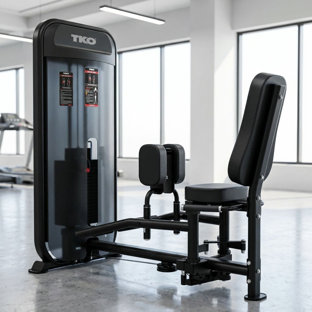 Black TKO TKO Achieve Dual Inner / Outer Thigh fitness machine in a gym setting