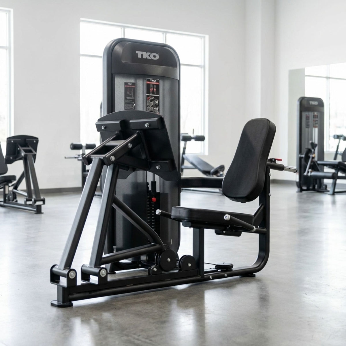 TKO Achieve Dual Leg Calf Press machine with TKO branding in a fitness center setting