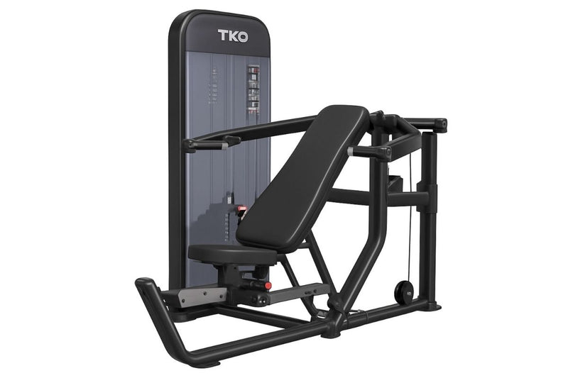 A TKO Achieve Dual Multi-press machine in black and dark gray, shown from a three-quarter angle on a solid white background.