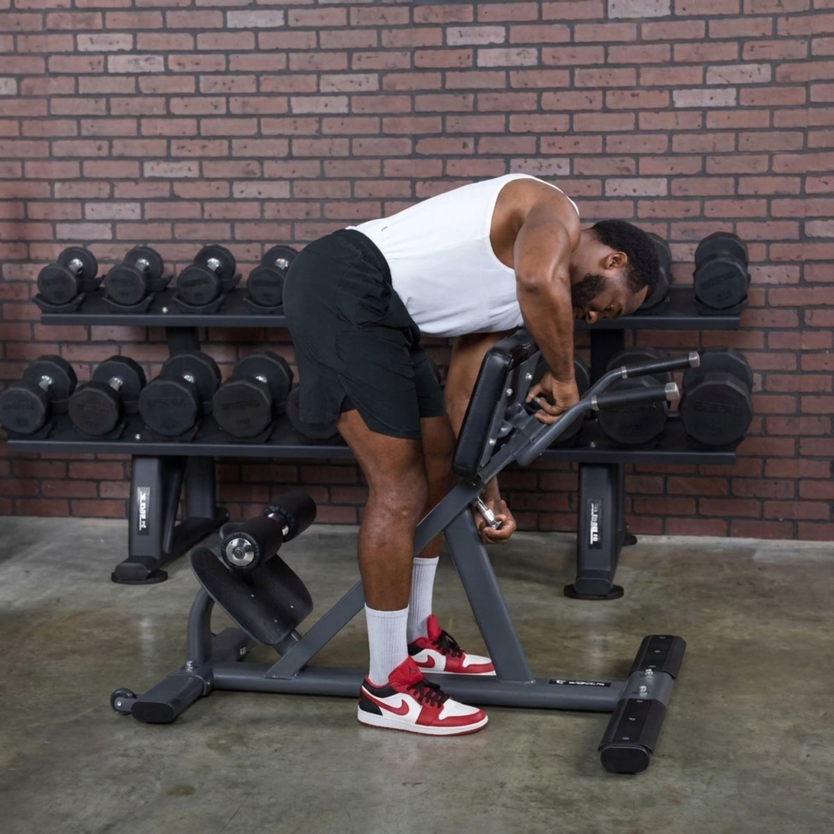 TKO Commercial Hyper Extension 876HP-man adjusting bench