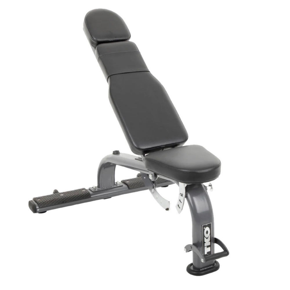 An adjustable TKO Commercial FID Dumbbell Bench with a black cushion, steel frame, and vinyl upholstery, designed for various workouts with incline and decline adjustments.
