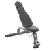 An adjustable TKO Commercial FID Dumbbell Bench with a black cushion, steel frame, and vinyl upholstery, designed for various workouts with incline and decline adjustments.