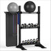 TORQUE Black metal wall base fitness storage rack with exercise balls, resistance bands, and kettlebells on a white background