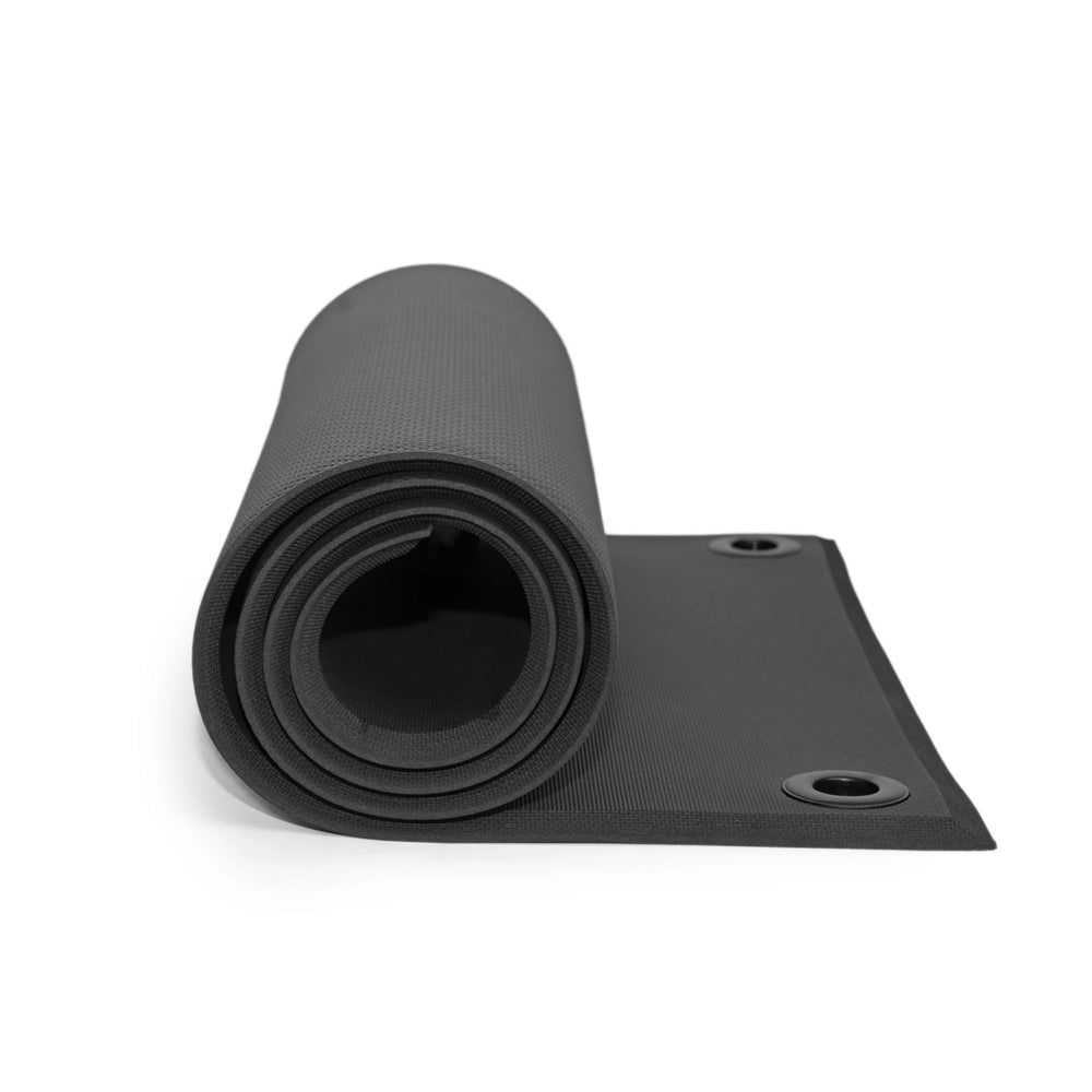 Black yoga mat rolled up on a white background
