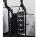 Black punching bag labeled 'Torque' hanging from a gym machine.