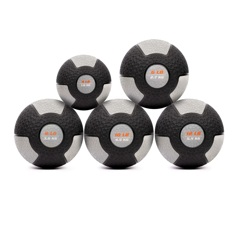 Set of five medicine balls with different weights on a white background