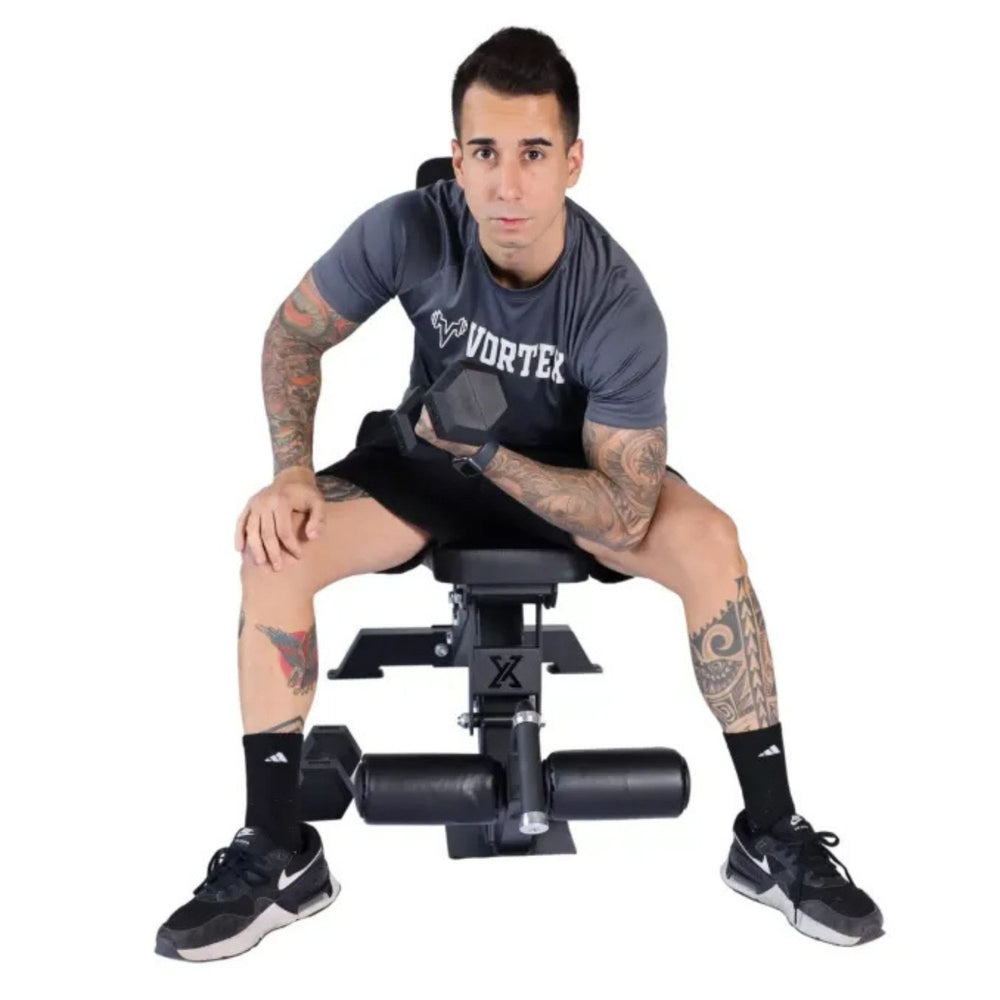 Vortex Commercial Adjustable Flat, Incline, Decline Bench with leg holders VXFIDL250 Man performing concentration curl with dumbbell on workout bench
