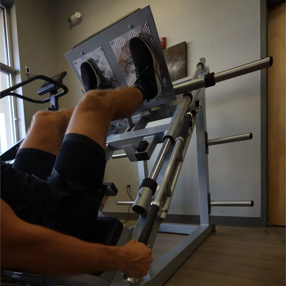 Vortex Commercial Hack Squat and Leg Press Combo VLP1000 Man performing leg press on VORTEX 45-degree machine with footplate and padded backrest