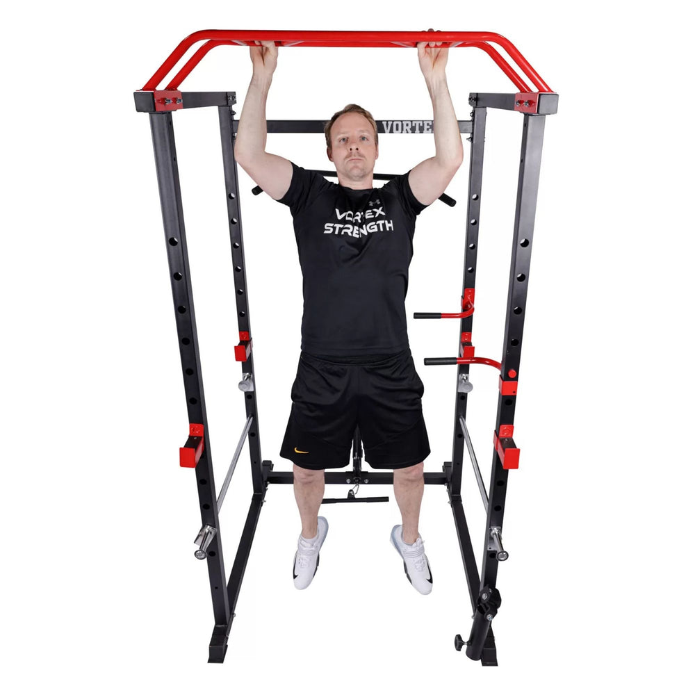 Vortex Olympic Squat Cage 1000 lb Weight Capacity Included with LAT Pulldown System RBVX10 Man performing pull-ups on red multi-grip bar