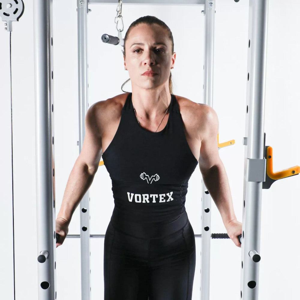 Vortex Squat Cage With High/low Pulley, Dip Attachments and Landmine SRVXG350 Front view of woman performing dips on functional Smith machine with cable pulley system