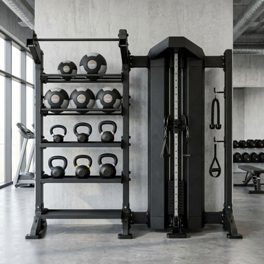 A black TORQUE multi-functional home gym cable machine paired with a matching multi-tier weight rack holding dumbbells and kettlebells, set in a modern concrete-floored gym.