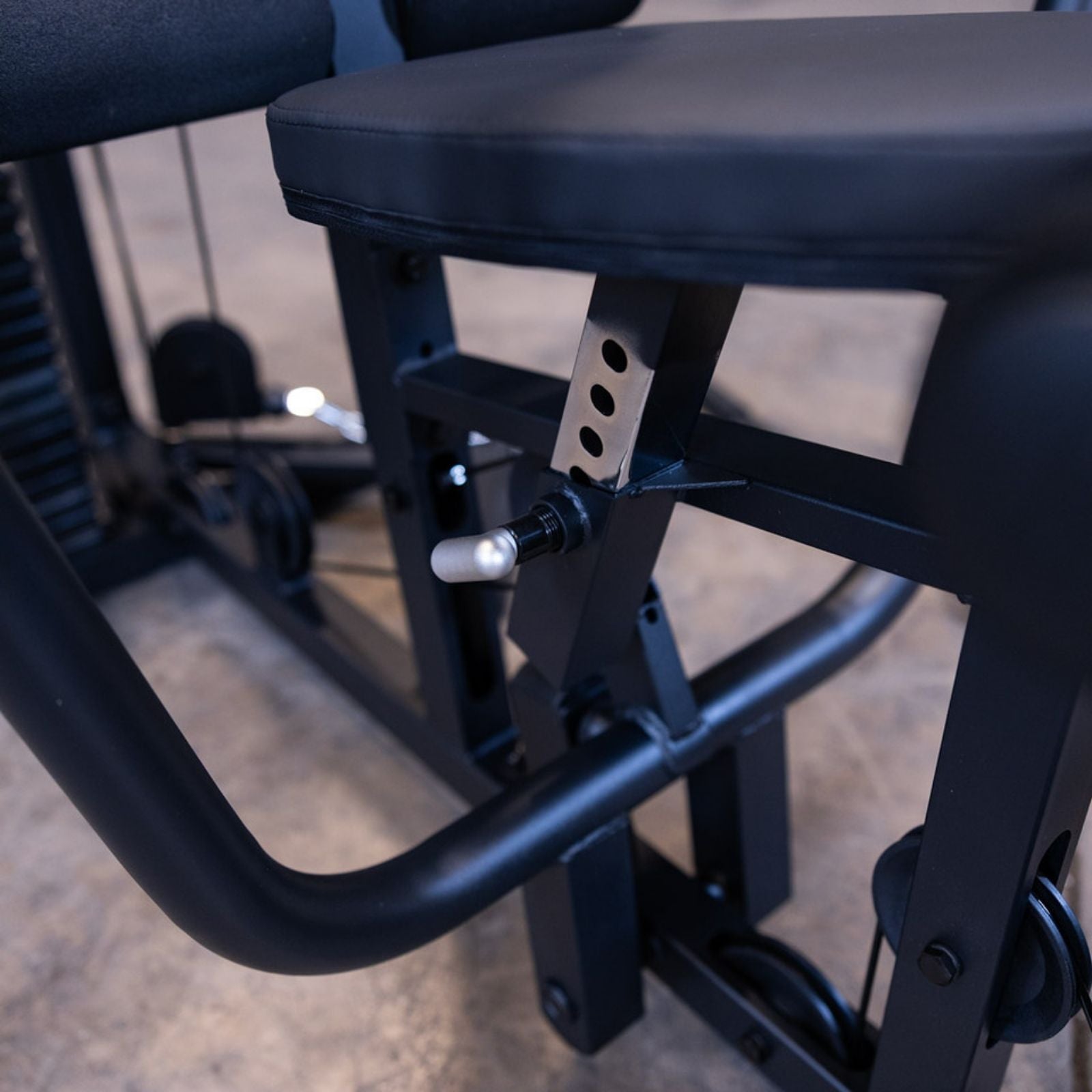 Close-up of the adjustable seat and pin-lock mechanism on the Body-Solid G1S Multi-Station Gym, showcasing build quality and user customization