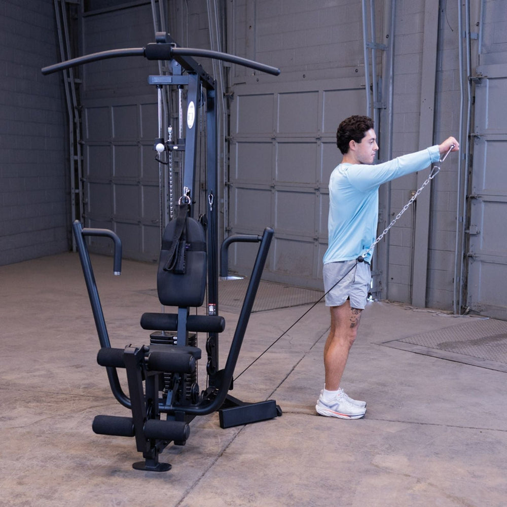 Man performing a cable front raise using the low pulley and single handle on the Body-Solid G1S Multi-Station Gym to target the front delts
