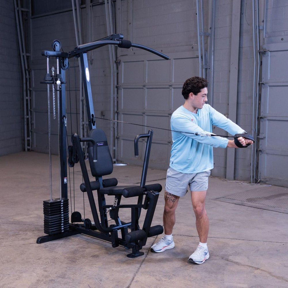 Man performing a standing cable woodchop exercise on the Body-Solid G1S Multi-Station Gym to target the obliques and core