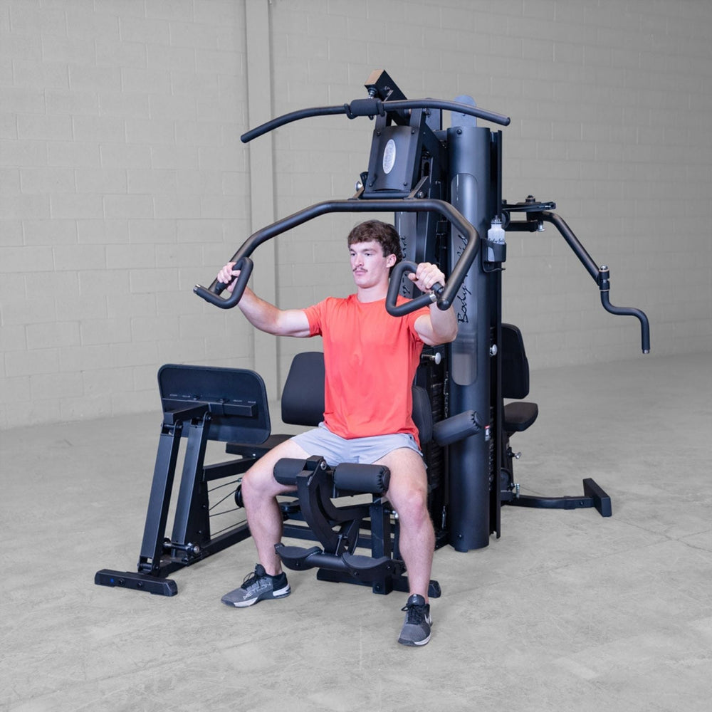 Front view of Body-Solid G9B multi-stack home gym showing chest press station and upper body press arms