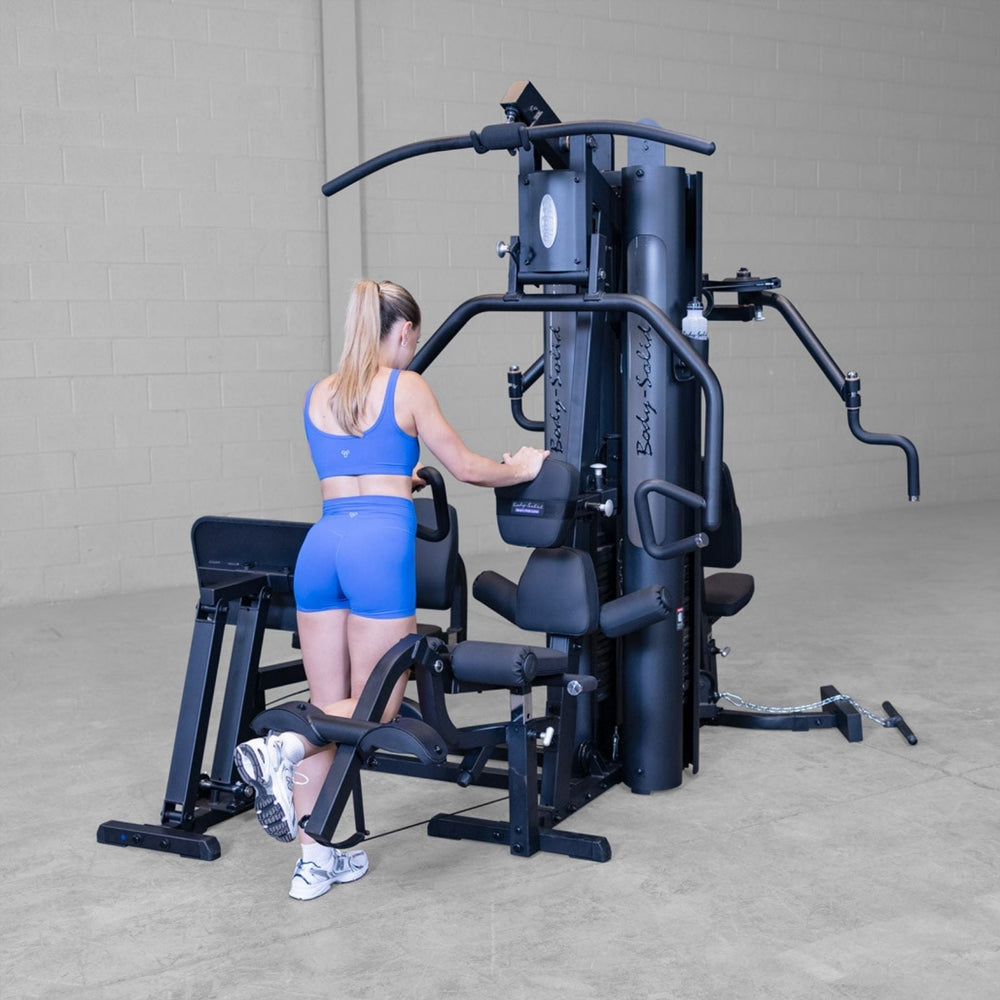 Rear view of Body-Solid G9B multi-stack home gym featuring leg curl and leg extension capability
