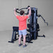 Body-Solid G9B dual stack home gym with user performing wide grip lat pulldown exercise

