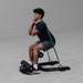 Man holding top position of sissy squat on Body-Solid GSS50B with resistance band