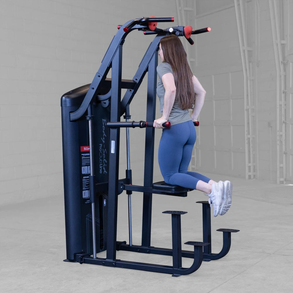 S2ACDX Series 2 Weight Assist Vertical Knee Raise Woman using a gym machine in a gray indoor setting