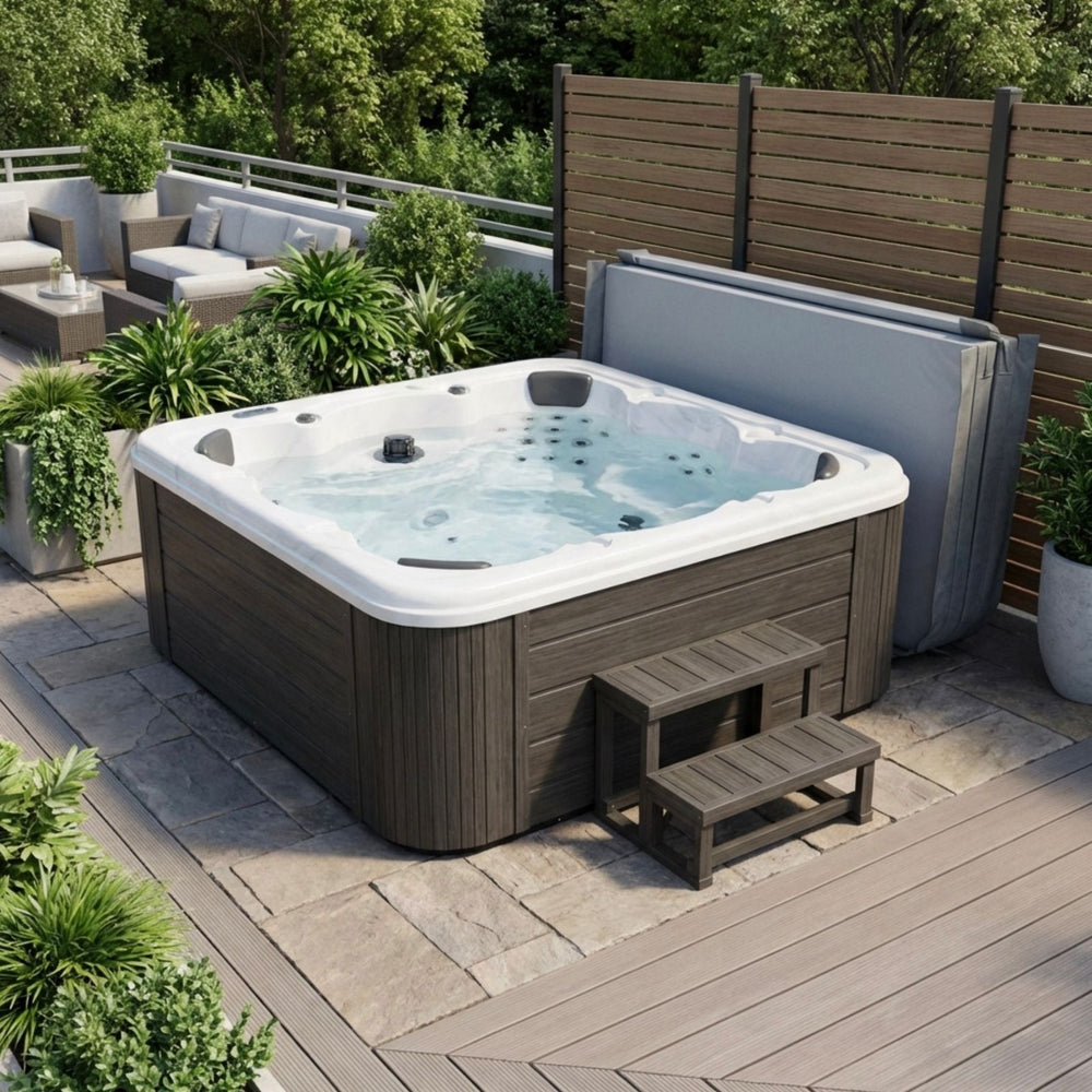 Large 7 person hot tub with steps and cover placed to the side on a spacious patio