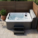 Luxury Spas Riley WS-291-CG hot tub with steps and cover placed to the side on a small patio