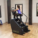 SportsArt ECO-POWR Stepper G778 side profile view with user climbing in studio setting